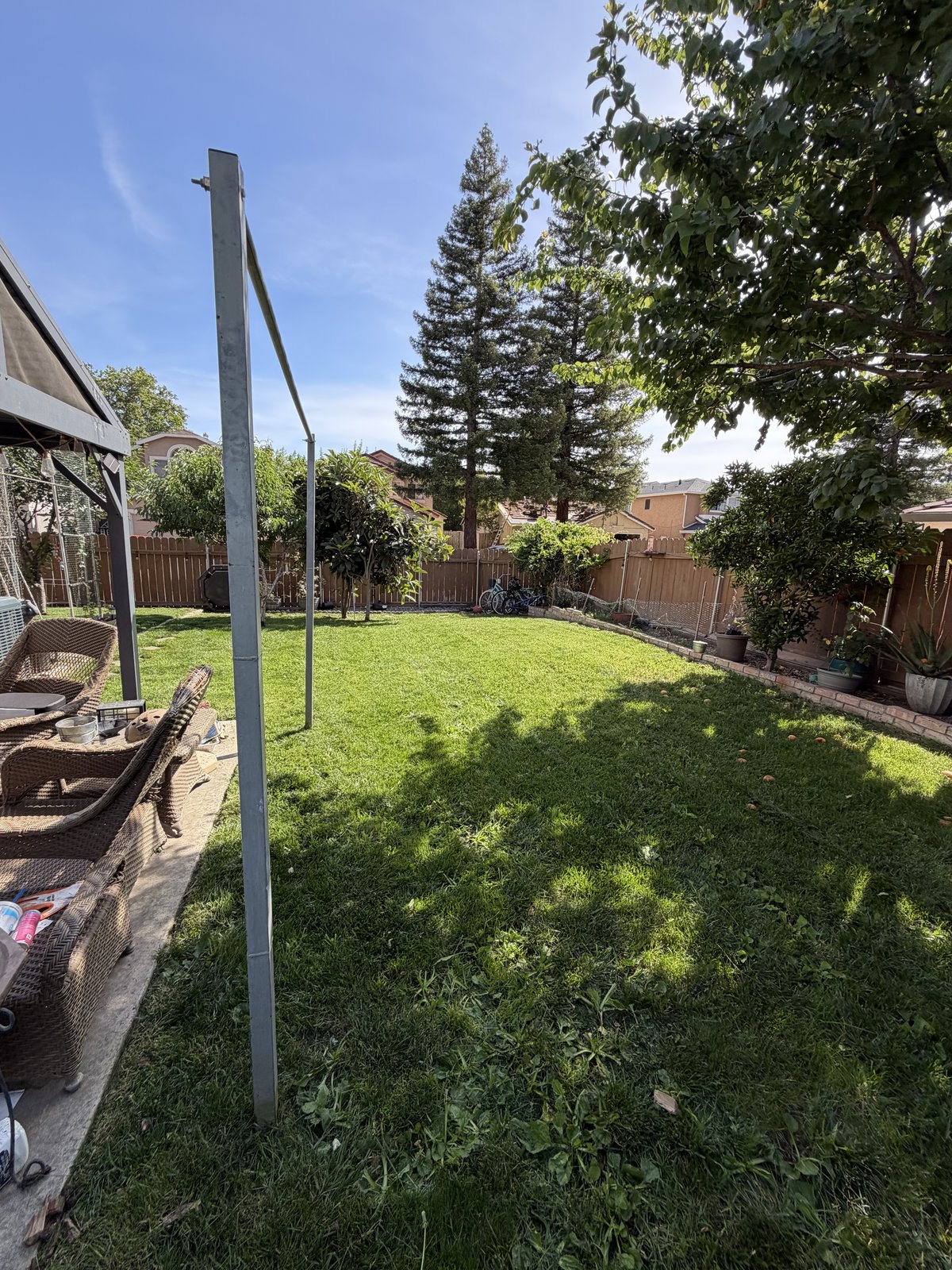 The same backyard cleared and mowed to a clean, even lawn